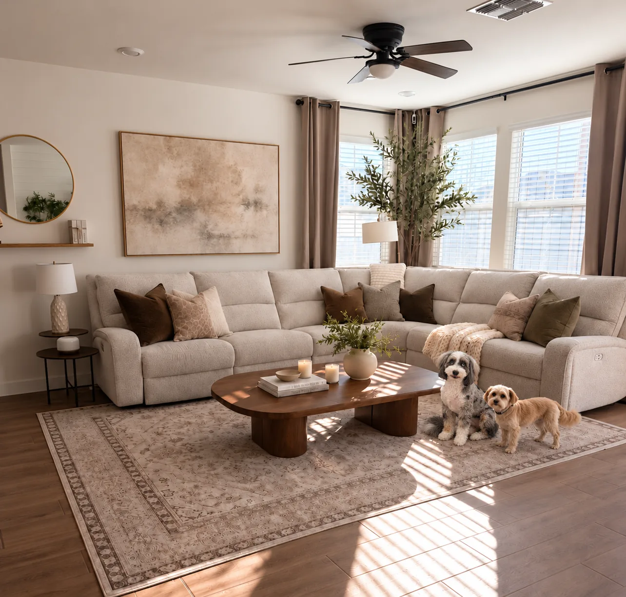 A bright, tidy living room with a cream sectional sofa, warm wood coffee table, and two small dogs resting at home